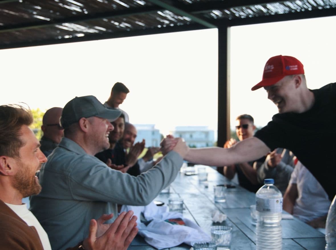 A handshake across the lunch table